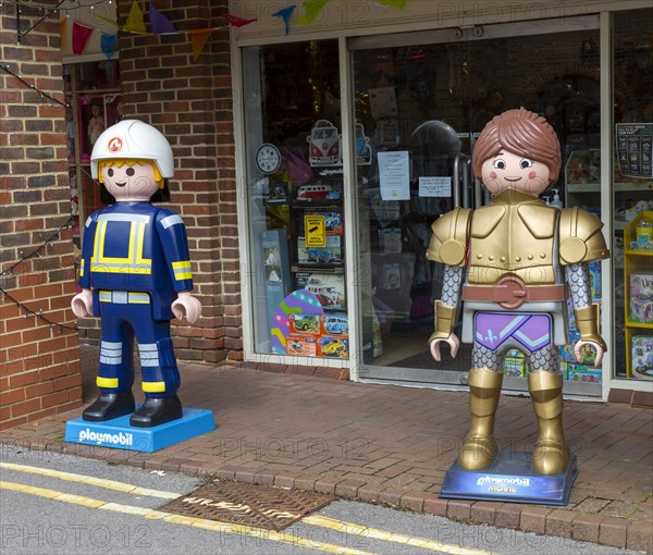 Giant Playmobil character models outside toy shop