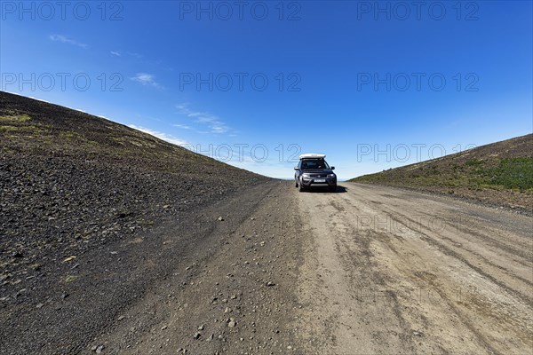 Off-road vehicle with roof tent in summer