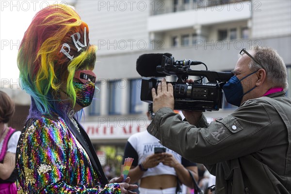Colourful outfit and first interview at start of 2021 Christopher Street Parade. Berlin
