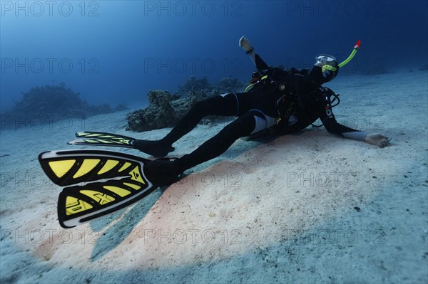 Dead diver lying on sandy bottom