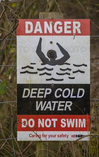 Sign warning of danger of deep cold water Hills waste management