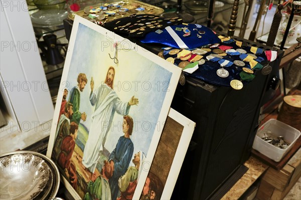 Image of Jesus and various orders for sale at a flea market