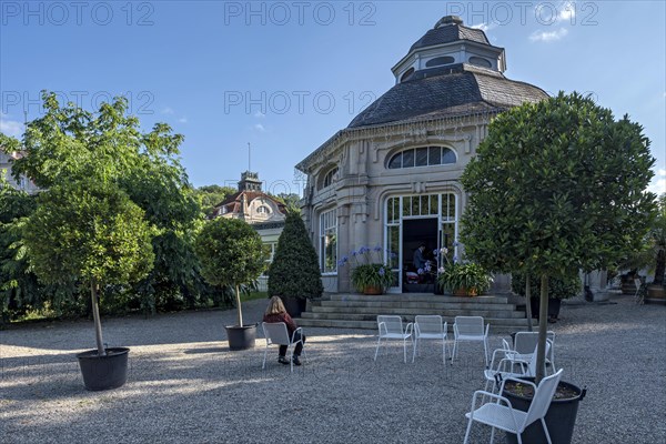 Spa guest sitting at the pavilion of the spa hotel in the spa garden