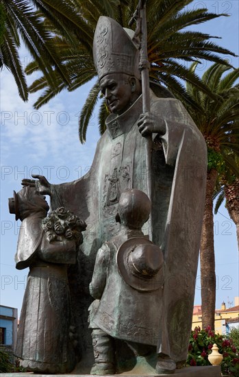 Statue of Pope John Paul II blessing 2 children