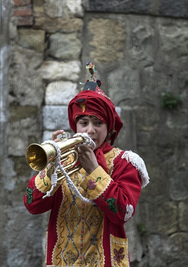 A youth dressed as one of the Judei with hood upturned