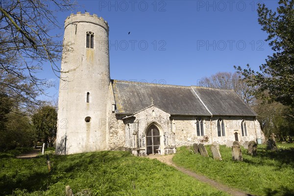 Round tower of medieval village parish church at