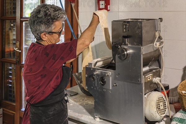 Preparing a lasagne in the kitchen of an agriturismo