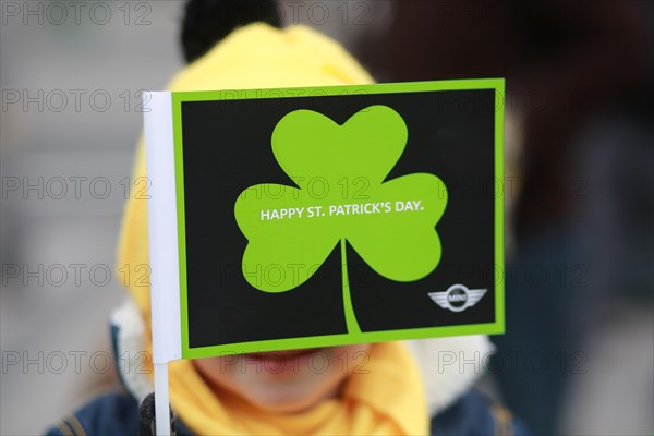 AHappy St Patricks Day shamrock held by young boy before the parade