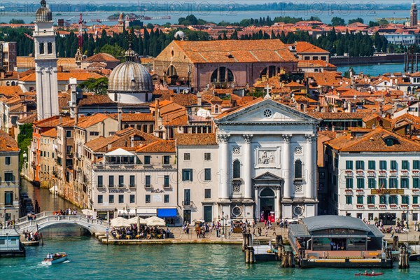 View of the waterfront and Castello district with Pieta church and Chiesa di San Giorgio dei Greci with the leaning tower