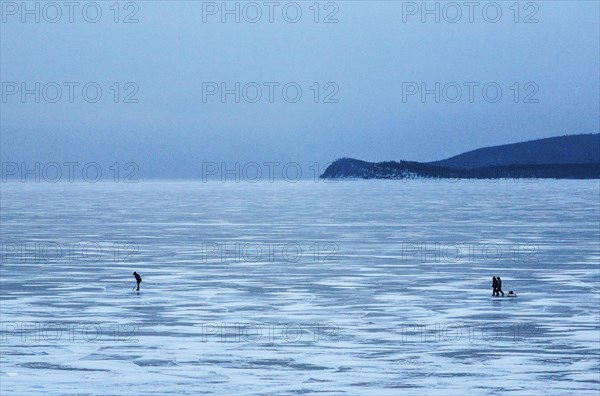 People dwarfed by their massive surroundings on Lake Baikal