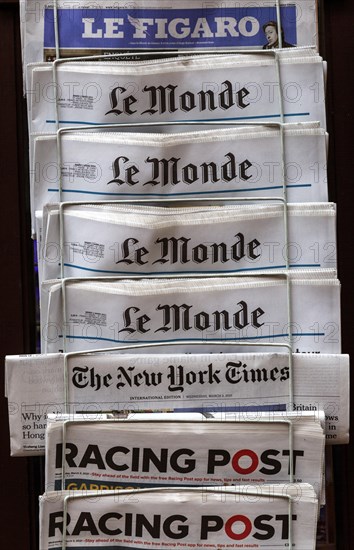 Newspapers in display rack outside newsagent shop