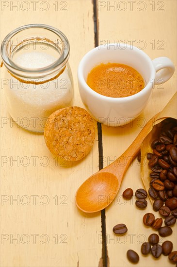 Espresso coffee and beans on a paper cone cornucopia over white background