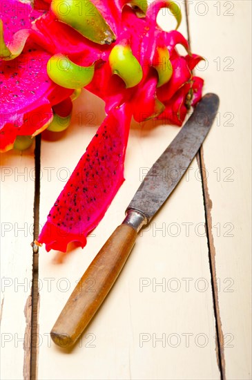 Fresh thai purple dragon fruit over white rustic table