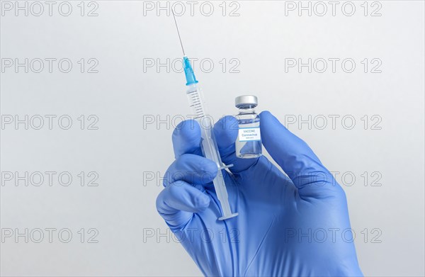 Doctor hands holding a vaccine bottle and syringe