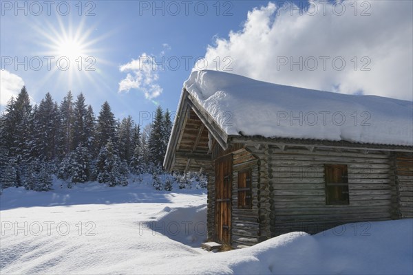 Winter landscape with wooden cabin