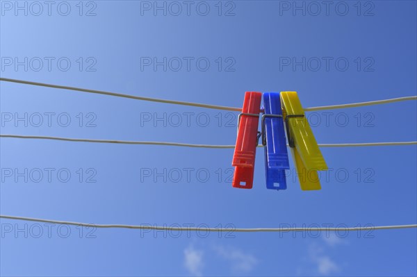 Clothesline with clothespins against blue sky