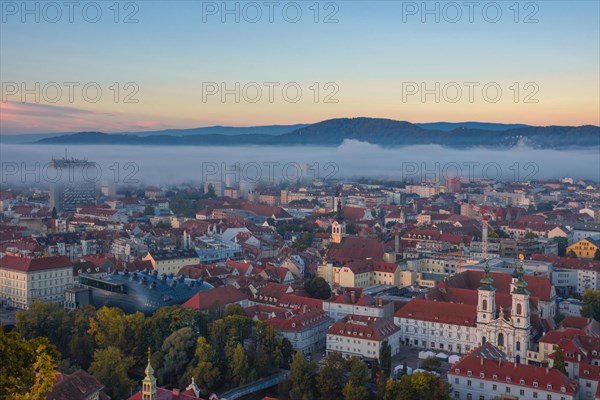 Cityscape of Graz with Mur river and Mariahilfer church