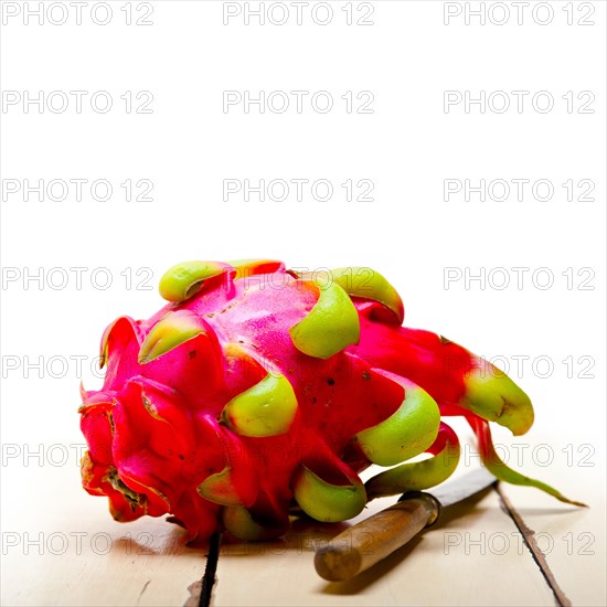 Fresh thai purple dragon fruit over white rustic table