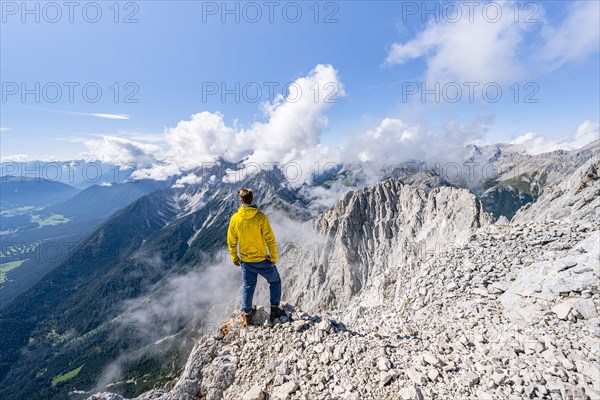 Hiker at the west summit of Hohe Munde