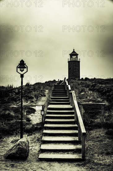 Cross light red cliff with wooden stairs