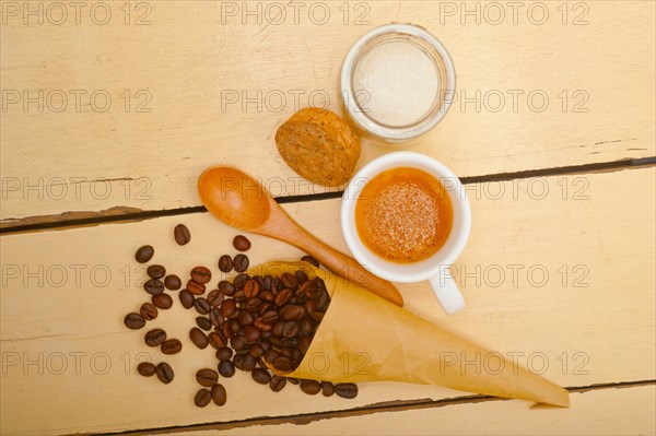 Espresso coffee and beans on a paper cone cornucopia over white background