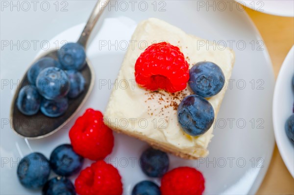 Fresh homemade raspberry and blueberry cream cake