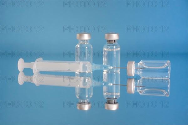 Vaccine bottles and syringe