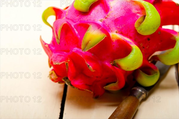 Fresh thai purple dragon fruit over white rustic table