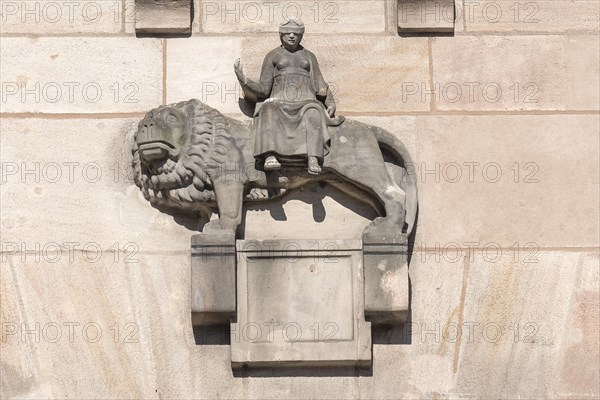 Sculpture of Justitia sitting on a lion