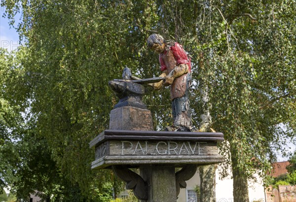 Model of blacksmith working on village sign for Palgrave