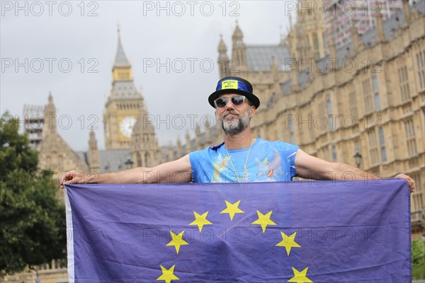 Anti-Brexit protest at parliament by man with EU flag in favor of remaining in the EU