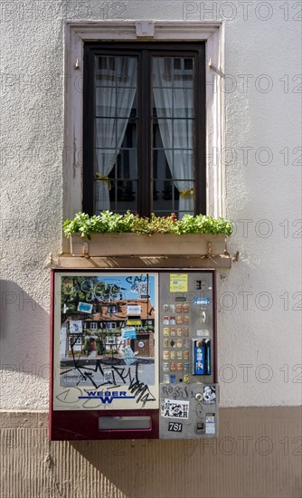 Old cigarette vending machine on the house wall