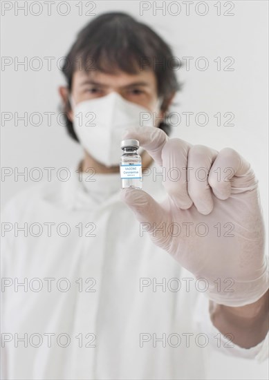 Doctor holding a vaccine bottle and syringe