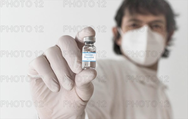 Doctor holding a vaccine bottle and syringe