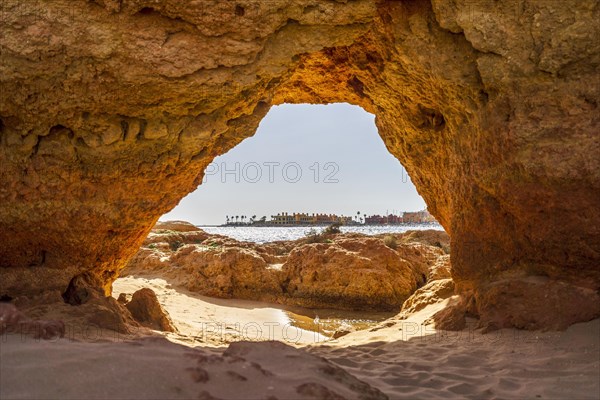 Beautiful sandstone arch with the view on marina in Portimao