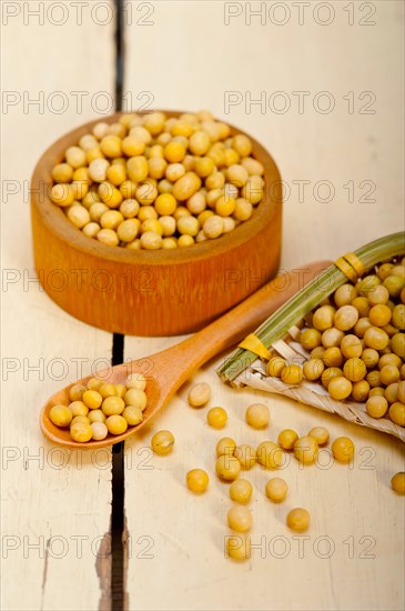 Organic soya beans over rustic wood table macro closeup