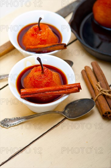 Poached pears delicious home made recipe ove white rustic wood table