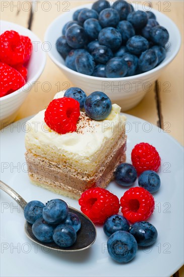 Fresh homemade raspberry and blueberry cream cake