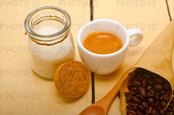 Espresso coffee and beans on a paper cone cornucopia over white background