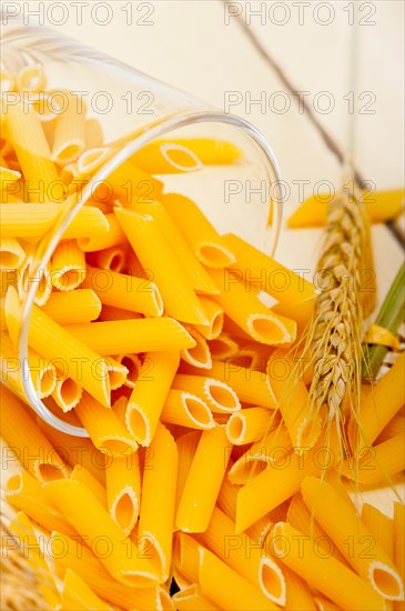 short Italian pasta penne with durum wheat grains