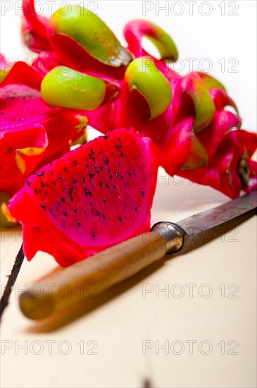 Fresh thai purple dragon fruit over white rustic table