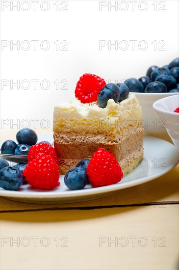 Fresh homemade raspberry and blueberry cream cake