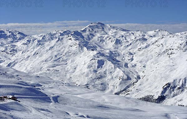 View of snow-capped mountains and landscape with ski slopes and La Masse summit