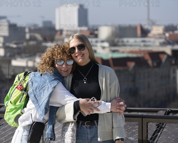 Two woman embrace on the terrace of the new Stadtschloss