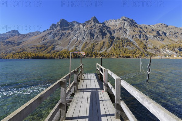 Wooden jetty on lake in autumn