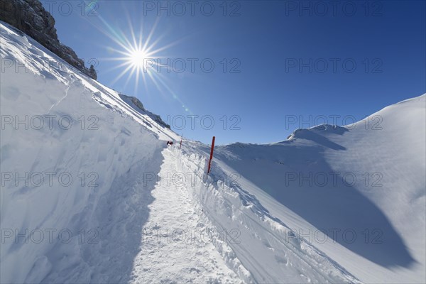 Path on Karwendelgrube Karwendel mountainrange with sun in winter