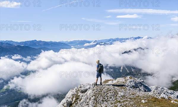 Hiker above the clouds