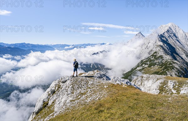 Hiker above the clouds