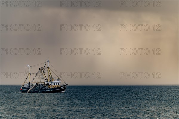Crab cutter in front of thunderstorm sky