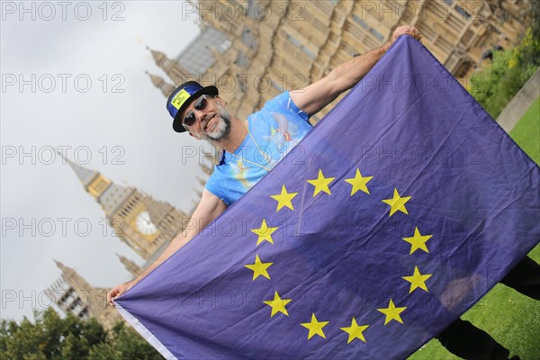 Anti-Brexit protest at parliament by man with EU flag in favor of remaining in the EU